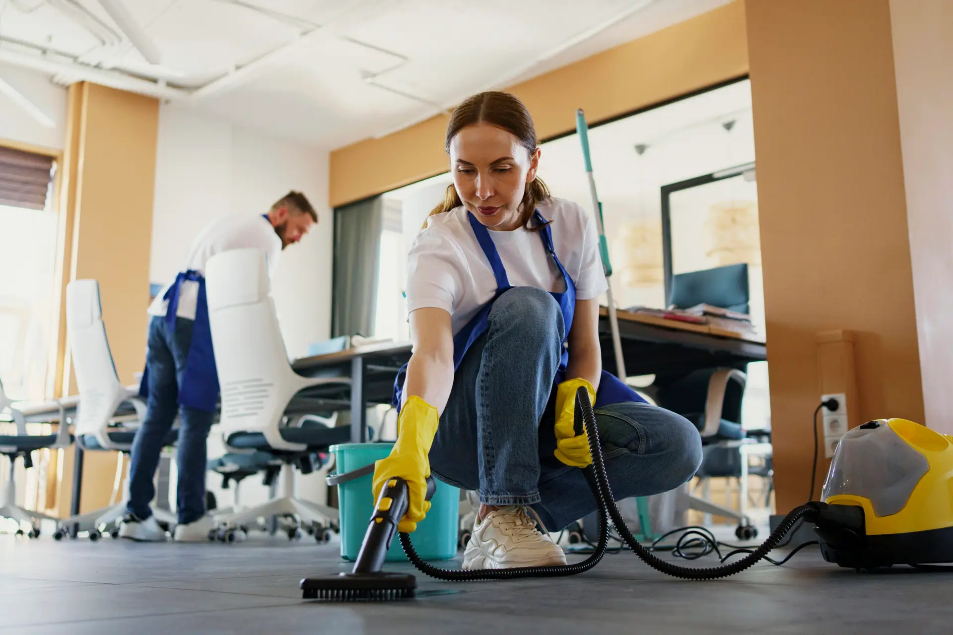 professional cleaning service person using vacuum cleaner office scaled